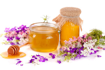 Obraz na płótnie Canvas Jar of honey with wildflowers isolated on white background
