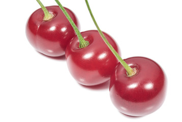 Three ripe cherry on the white background
