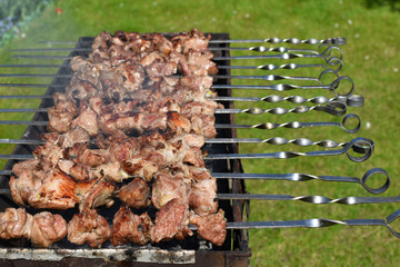 Grilling marinated meat on a brazier.