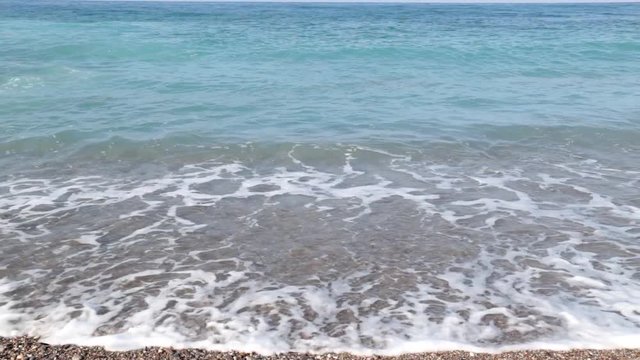 Sea waves roll out onto the beach. The sea, the ocean, the surf. Sea wave and foam.