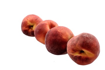 A few ripe peaches isolated on a white background