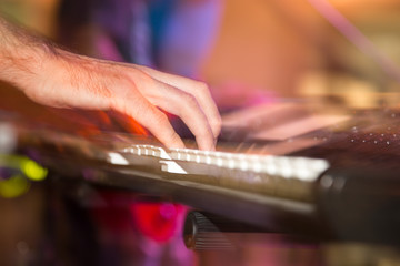 Musician plays keyboards in a rock band