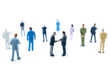 Miniature people shaking hands, Business concept.
