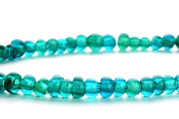 Ancient glass trade beads in necklace on white background