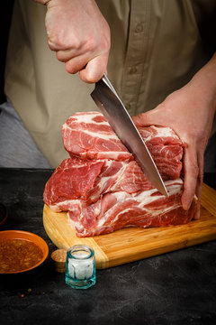 Close up of Male hands chopping knife pork