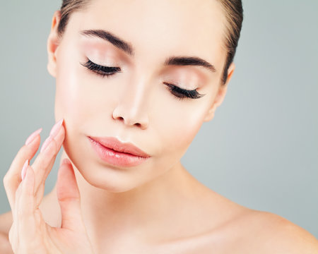 Healthy Model Woman with Skin touching her Hand her Face. Skincare, Facial Treatment and Cosmetology
