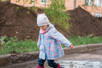 Child playing in the muddy puddle