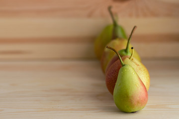 Fresh pears on the wooden table.