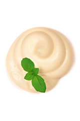 Mayonnaise swirl with a mint leaf isolated on a white background close-up. Top view