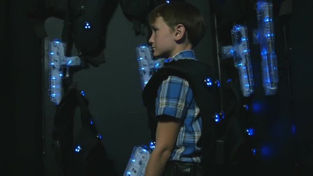 Boy takes aim at a lasertag weapon