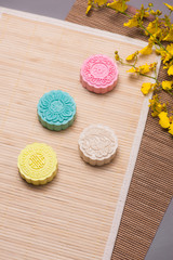 Traditional mooncakes on table setting. Snowy skin mooncakes. Chinese mid autumn festival foods.