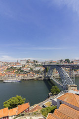 Fototapeta na wymiar View of Ribeira historical quarter, on the margin Douro river embankment Oporto old town and Luis I bridge, Porto.