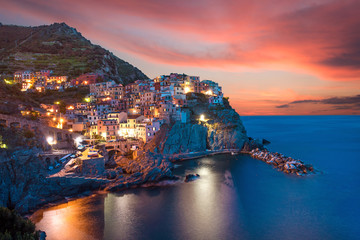 Magical beautiful landscape with bright colored houses on the rock on the sea coast of Manarola in...