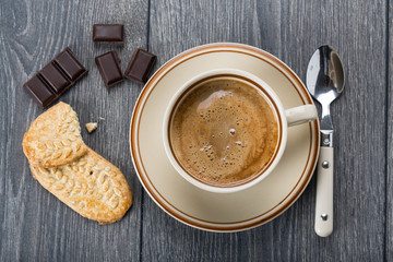 A cup of coffee and biscuits