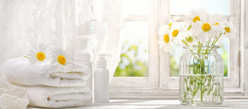 towel with daisy flowers near window