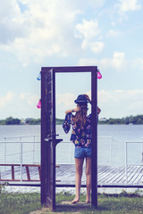 Portrait with a woman at a door near the lake