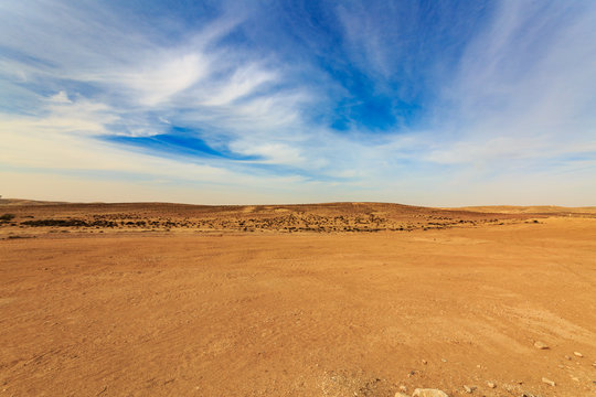 Wide panorama of Negev desert with clouds at wind
