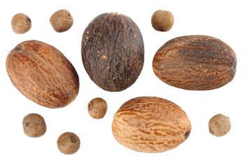 Nutmeg with peppercorns isolated on white background
