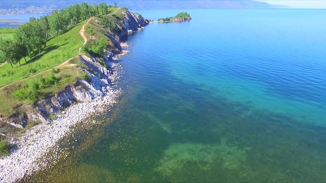 Cape Shamanka on the Lake Baikal and flying Seagull shot from above with quadcopter in the Siberian region of Russia.