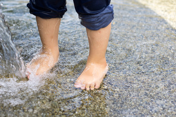 Children's feet playing in the water