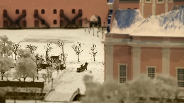 View of the old town, horse-drawn carriage rides through the snow-covered road it's snowing