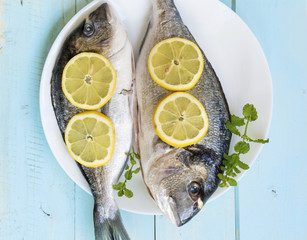 Fresh raw fish with lemon slices