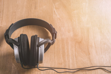 Stereo Headphones on wooden table copy space for text.