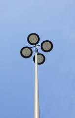 Outdoor or Street Light Fixture and Pole on Blue Sky Background