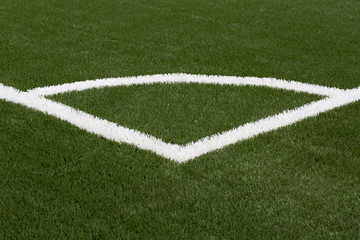 Obraz premium A closeup photo taken on a football field line paint marking.