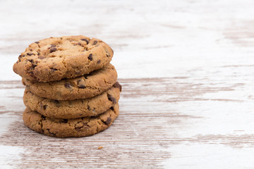 chocolate cookies tower on white wooden background