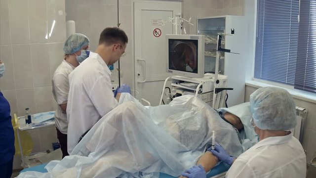 Medical team conducting surgery using endoscope
