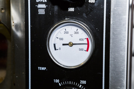 Temperature sensor on an industrial dirty black metal oven