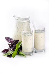 Traditional Turkish yogurt Ayran drink with mint leaves isolated on white