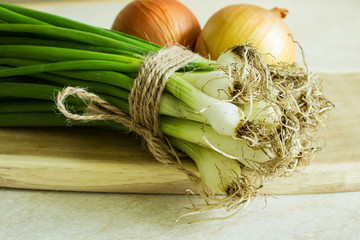 Different kinds of onions on a wooden board. Selective focus. Close-up. ©  Iryna	