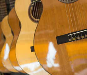 Obraz premium Many Classical Guitars Hanging on Wall in the Shop
