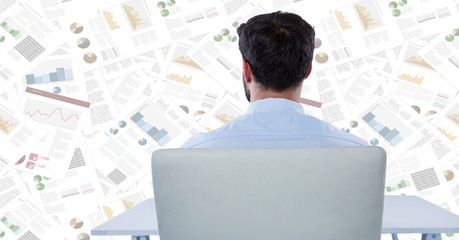 Back of business man at desk against document backdrop
