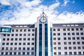 Fototapeta na wymiar Multi-storey building with clock