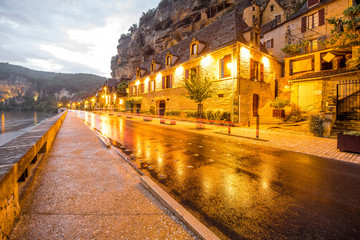 Fototapeta na wymiar Beautiful street view on the illuminated La Roque Gageac village during the rainy weather in France