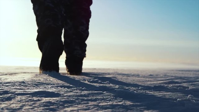 Polar explorer feet walking on snow in winter