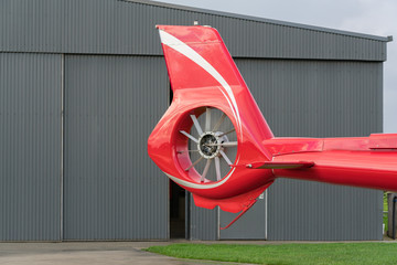 close up the tail rotor of a red helicopter.
The tail rotor is a smaller rotor mounted so that it...