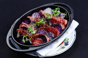 Stew meat with slices of beetroot.