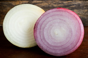 fresh sweet onion and red onion on wooden background.