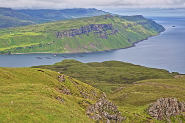 Fototapeta premium View from the mountain Ben Tianavaig towards the Trotternish peninsula and with the Old Man of Storr in the background, Isle of Skye, Highlands, Scotland, UK