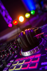 Plakat Dj mixer with headphones at a nightclub
