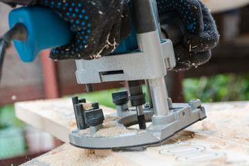 milling-machine wood. The man mills a tree.