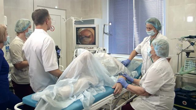 Medical team performing gastro-endoscopy to patient in hospital