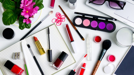 cosmetics top view on a white table. Workplace, cosmetic bag