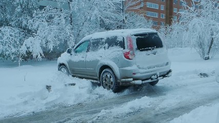 Car wheels riding on deep snow at winter season - Powered by Adobe
