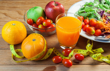 Healthy concept with mixed fruits and vegetables on wooden background