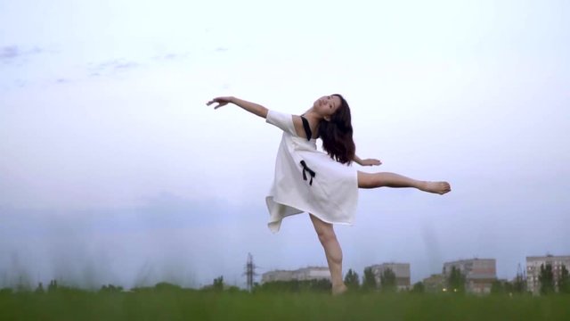 Slow motion shooting of a dancing Japanese ballerina in a white dress
